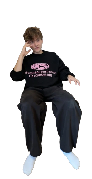 Moritz sitting relaxed, one hand at his temple